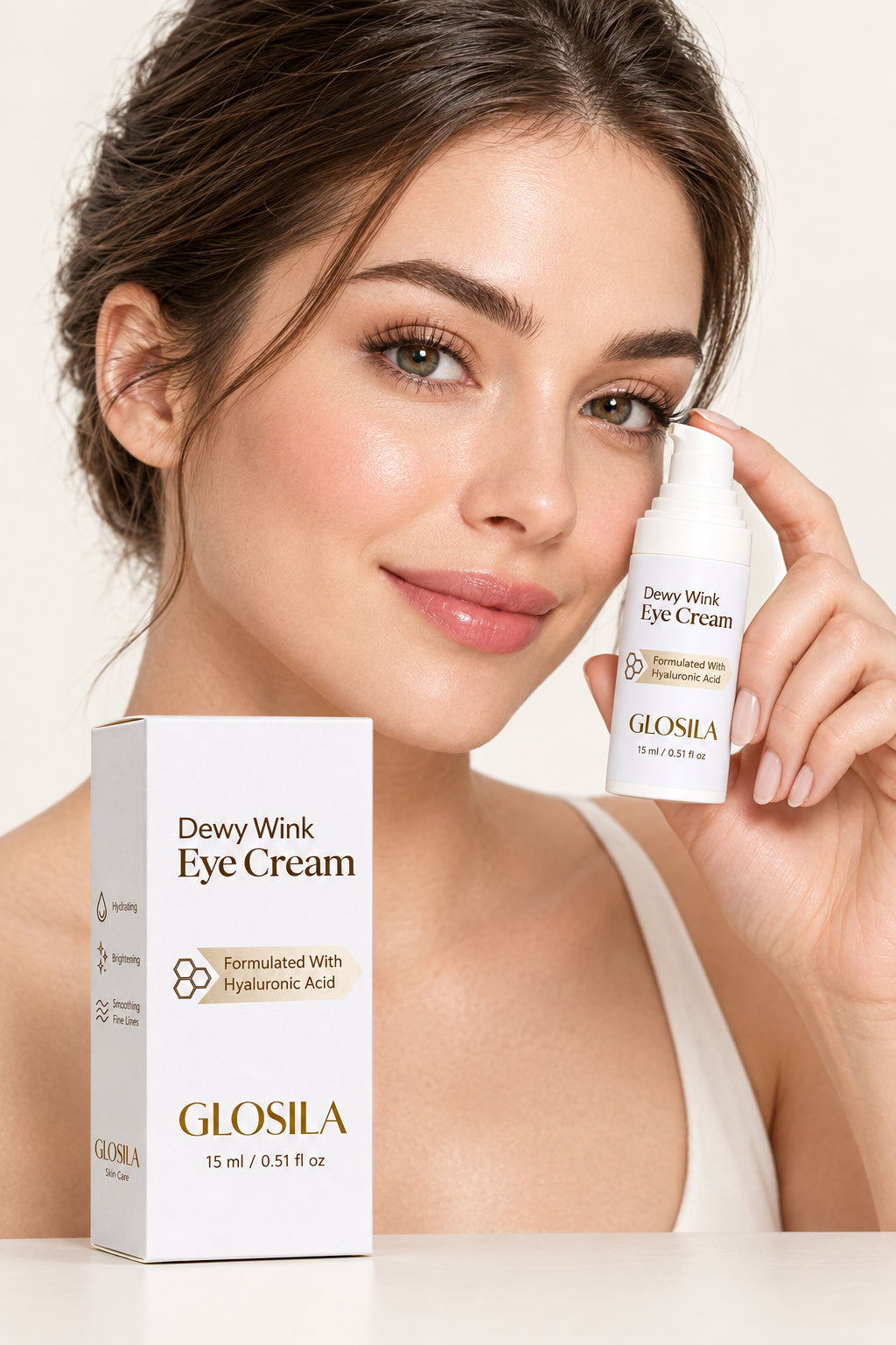 Glossila Dewy Wink Eye Cream shown with its white and light purple packaging box and matching pump bottle on a clean soft grey background.